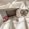 Elegant heart charm bracelet displayed with engraved gift box and Mother’s Day treat