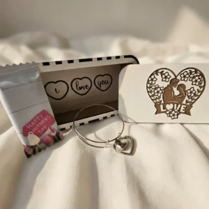 Heart charm bracelet gift set with gift box and Mother’s Day sweet in soft natural lighting