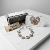 Personalised Mother’s Day charm bracelet with photo charms displayed with wooden gift box on marble background